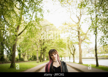 Portrait of beautiful woman standing in park Stock Photo