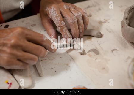 Hand of woman shaping clay in drawing class Stock Photo