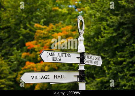 Traditional style signpost pointing to Jane Austen's house on the village green at Chawton, Hampshire, southern England, UK Stock Photo