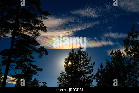 iridescent or Nacreous clouds over Tiveden National Park in Sweden Stock Photo