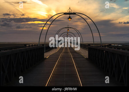 Southport Pier, England at sunset with orange clouds and blue sky Stock Photo