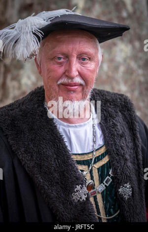 A distinguished older gentleman in traditional costume representing a member of the King's court during a Renaissance fair held in southern France Stock Photo