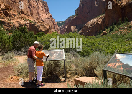 Caucasian Senior Couple (age 60-70) reading information board at Kolob Canyons at Zion National Park Springdale, Utah USA.. Stock Photo