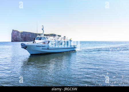 Perce, Canada - June 6, 2017: Boat with Capitaine Duval II sign swimming up to dock for tourist boat trip to Rocher Perce rock and Bonaventure island  Stock Photo