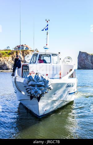 Perce, Canada - June 6, 2017: Boat with Capitaine Duval II sign swimming up to dock for tourist boat trip to Rocher Perce rock and Bonaventure island  Stock Photo