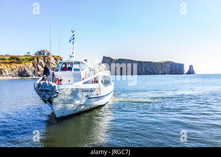 Perce, Canada - June 6, 2017: Boat with Capitaine Duval II sign swimming up to dock for tourist boat trip to Rocher Perce rock and Bonaventure island  Stock Photo