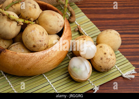 Ripe lanzones fruit on wooden table Stock Photo