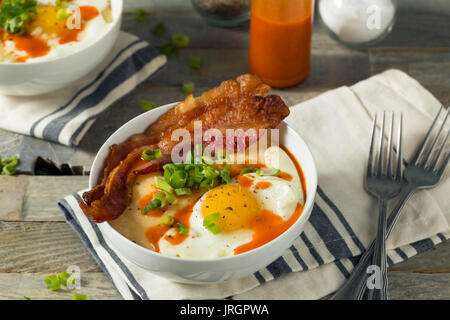 Homemade Cheesy Breakfast Grits with Eggs and Bacon Stock Photo