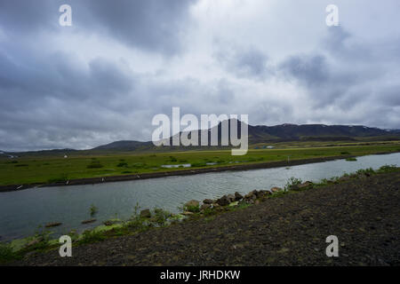 Iceland - River between volcanic mountains and green meadows Stock Photo