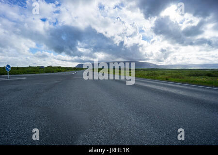 Iceland - Highway intersection between green meadows Stock Photo