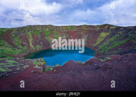 Iceland - Magical moment at Kerid Crater Lake with red stones Stock Photo