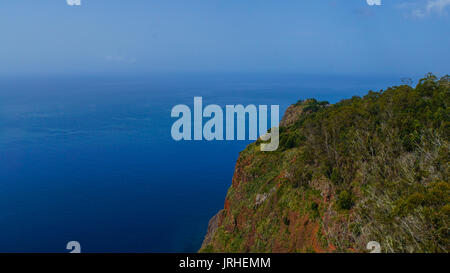 Madeira - Green cliffs with infinite blue ocean from viewpoint Cabo Girao Stock Photo