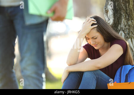 Couple of students breaking up a relationship with the guy leaving his girlfriend Stock Photo