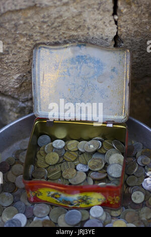 Old aged coins in the metal box Stock Photo