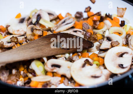 Roasted vegetables on cooking pan. Carrots, mushrooms, leeks, meat. Stock Photo