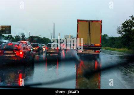 Danger of a traffic jam in heavy rain. Severe weather on the highway and bad driving conditions. Stock Photo