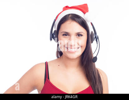 Christmas headset woman from telemarketing call center wearing red santa hat talking smiling isolated on white background. Stock Photo