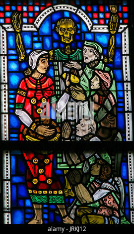 Stained Glass in Wormser Dom in Worms, Germany, depicting the Works of mercy, here: feed the hungry Stock Photo