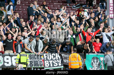 Hannover 96 ultras show their support in the stands before the pre-season friendly match at Turf Moor, Burnley. Stock Photo