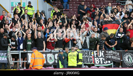 Hannover 96 ultras show their support in the stands before the pre-season friendly match at Turf Moor, Burnley. Stock Photo