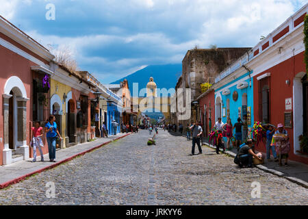 Antigua, Guatemala - April 16, 2014: View of a cobblestone street in the old city of Antigua with the Agua Volcano on the background, in Guatemala Stock Photo