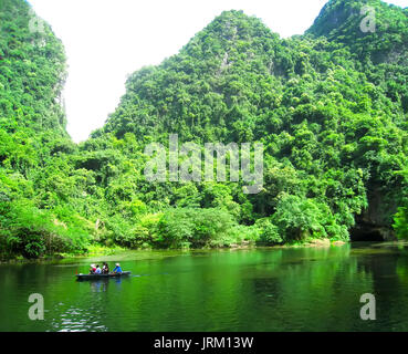 NINH BINH, VIETNAM, JULY, 20: Unidentified tourists in Trang An  on JULY, 20, 2013. Trang An is the scenic area, ranked special of Vietnam. Stock Photo