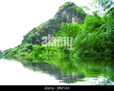 NINH BINH, VIETNAM, JULY, 20: Unidentified tourists in Trang An  on JULY, 20, 2013. Trang An is the scenic area, ranked special of Vietnam. Stock Photo