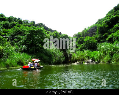 NINH BINH, VIETNAM, JULY, 20: Unidentified tourists in Trang An  on JULY, 20, 2013. Trang An is the scenic area, ranked special of Vietnam. Stock Photo