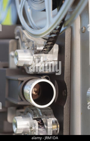 A large film reel is mounted on a vintage Super 8 movie projector Stock Photo