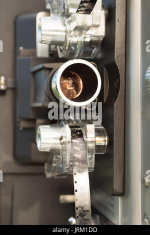 A large film reel is mounted on a vintage Super 8 movie projector Stock Photo