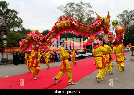 HAI DUONG, VIETNAM, February 14: a group of Asian people dance dragon in folk festivals on February 14, 2014 in Con Son pagoda, Hai Duong, Vietnam. Stock Photo