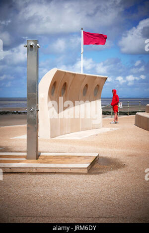 Life guard and red no swimming flag flying on Cleveleys beach Stock Photo