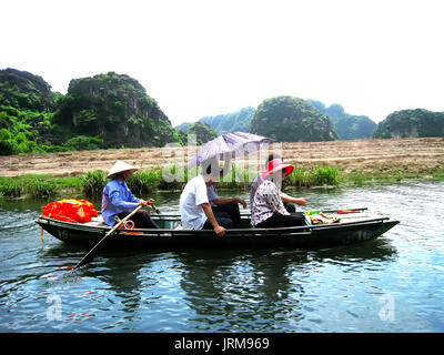 NINH BINH, VIETNAM, JULY, 20: Unidentified tourists in Trang An  on JULY, 20, 2013. Trang An is the scenic area, ranked special of Vietnam. Stock Photo