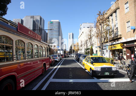 A busy street in Yokohama with a bus and taxi Stock Photo