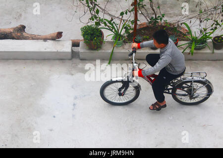 HAI DUONG, VIETNAM, DECEMBER, 6: Asian young people playing football on december, 6, 2014 in Hai Duong, Vietnam. Stock Photo