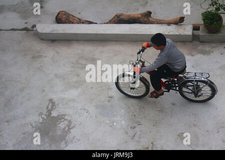 HAI DUONG, VIETNAM, DECEMBER, 6: Asian young people playing football on december, 6, 2014 in Hai Duong, Vietnam. Stock Photo