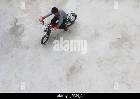 HAI DUONG, VIETNAM, DECEMBER, 6: Asian young people playing football on december, 6, 2014 in Hai Duong, Vietnam. Stock Photo