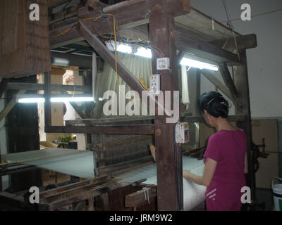 HAI DUONG, VIETNAM, JULY 30: Asian woman spinning and weaving on july, 30, 2014 in Hai Duong, Vietnam. This is special characteristics of rural Vietna Stock Photo