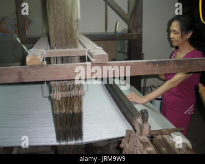 HAI DUONG, VIETNAM, JULY 30: Asian woman spinning and weaving on july, 30, 2014 in Hai Duong, Vietnam. This is special characteristics of rural Vietna Stock Photo