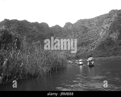 NINH BINH, VIETNAM, JULY, 20: Unidentified tourists in Trang An  on JULY, 20, 2013. Trang An is the scenic area, ranked special of Vietnam. Stock Photo