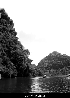 NINH BINH, VIETNAM, JULY, 20: Unidentified tourists in Trang An  on JULY, 20, 2013. Trang An is the scenic area, ranked special of Vietnam. Stock Photo