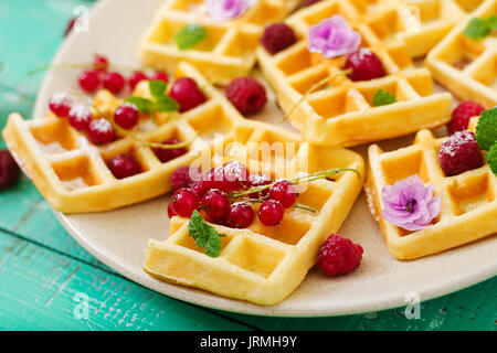 Belgium waffles with raspberries and yogurt on plate. Stock Photo