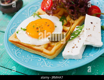 Healthy breakfast - waffles, eggs, feta cheese, tomatoes and lettuce Stock Photo