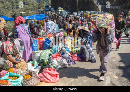 Man carrying sack through outdoor market area, Mawsynram, Meghalaya, India Stock Photo