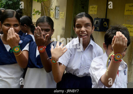 Kolkata, India. 05th Aug, 2017. Blind girl students enjoy their Rakhi or sacred thread during the Raksha bandhan or Rakhi festval celebration in Kolkata. Blind student of The Light House for the Blind celebrate Rakhi Festival on August 5, 2017 in Kolkata. Raksha bandhan or Rakhi means 'bond of protection' observe annual on the full moon of Hindu calendar Shravana that schedule on August 07 this year. Sister ties a rakhi or sacred thread on her brother's wrist with a prayer for his prosperity and happiness on Raksha bandhan or Rakhi festival. Credit: Saikat Paul/Pacific Press/Alamy Live News Stock Photo