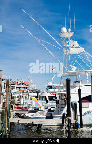 Colorful directional sign or signs pointing to charter fishing boat slips  for the commercial fishing fleet at HarborWalk Marina in Destin Florida USA  Stock Photo - Alamy