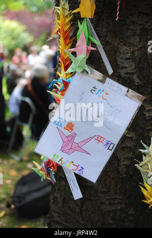 London, UK. 06th Aug, 2017. A child's drawing of a crane (a traditional Japanese symbol for peace) hanging on the memorial cherry tree in Tavistock Square during the Campaign for Nuclear Disarmament’s annual commemoration of the atomic bombing of Hiroshima, Japan in Tavistock Square, London, United Kingdom.   The tree was planted in the square by Camden Council in 1967 in memory of the victims of the bombing. Since then an annual ceremony has been held around the tree to remember the attack.  The attack took place at 8. Credit: Michael Preston/Alamy Live News Stock Photo