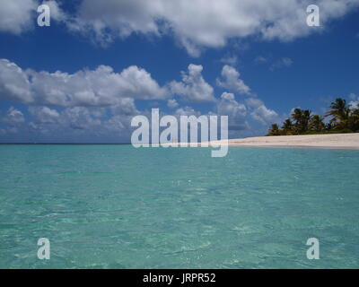 Two people in the distance walking along an otherwise deserted beach, Shoal Bay, Anguilla, BWI. Stock Photo
