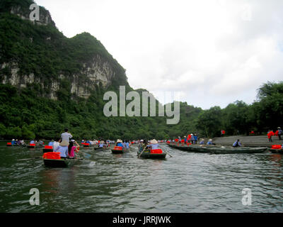 NINH BINH, VIETNAM, JULY, 20: Unidentified tourists in Trang An  on JULY, 20, 2013. Trang An is the scenic area, ranked special of Vietnam. Stock Photo