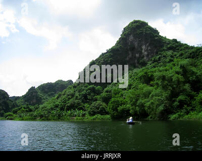 NINH BINH, VIETNAM, JULY, 20: Unidentified tourists in Trang An  on JULY, 20, 2013. Trang An is the scenic area, ranked special of Vietnam. Stock Photo